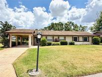 Charming single-story home with well-maintained lawn and covered parking at 503 Finsbury Cir # A, Sun City Center, FL 33573