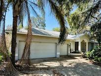 Charming one-story home with a three-car garage and a well-maintained front yard and porch entrance at 6425 Brentwood Dr, Zephyrhills, FL 33542