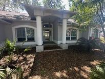 Charming single-story home with well-maintained landscaping and a covered front entry with columns at 6433 Brentwood Dr, Zephyrhills, FL 33542
