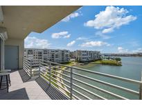 Balcony view of waterfront condos and community, with manicured landscaping and serene water at 7912 Sailboat Key S Blvd # 508, South Pasadena, FL 33707