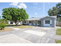 Charming single-story home featuring a well-maintained front yard and a concrete driveway on a sunny day at 9118 108Th Ave, Seminole, FL 33777
