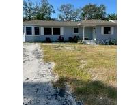 Charming single-story home featuring a well-maintained lawn and a welcoming entrance at 1379 Pine St, Clearwater, FL 33756