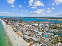 Stunning aerial view of the beach condos, coastline, and ocean waterways at 14900 Gulf Blvd # 212, Madeira Beach, FL 33708