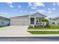 Charming single-story home featuring a manicured lawn, stone accents and a two-car garage at 1499 Gopher Loop, Tarpon Springs, FL 34689