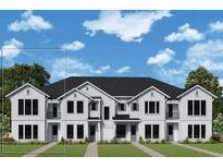 New two-story townhome featuring symmetrical design, multiple windows, and manicured lawn at 1631 Springwell Ln, Sarasota, FL 34240