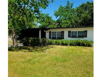 Charming single-story home with a well-manicured lawn and beautiful mature trees at 2204 Euclid S Cir, Clearwater, FL 33764