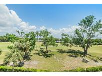 Beautifully landscaped grounds with mature trees and views of the bay create a serene outdoor environment at 2617 Cove Cay Dr # 401, Clearwater, FL 33760