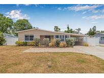 Charming single-story home featuring a spacious front yard and covered parking at 2861 Pinellas Point S Dr, St Petersburg, FL 33712