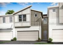 Modern townhome featuring neutral colors, a two-car garage, and manicured landscaping at 3464 Timber Crossing Ave, Brandon, FL 33511