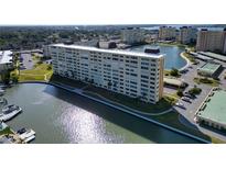 Stunning aerial view of waterfront apartment building with boat docks and scenic water views at 4725 Cove Cir # 601, St Petersburg, FL 33708