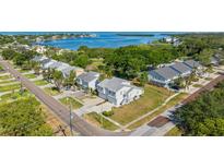 An aerial view of a neighborhood with waterfront access featuring townhouses and a view of the bay at 581 Oceanview Ave, Palm Harbor, FL 34683