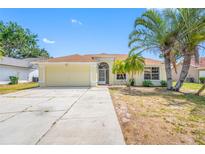 Charming single-story home with a two-car garage, and beautiful palm trees enhancing its curb appeal at 709 47Th E St, Bradenton, FL 34208