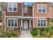 Charming townhome with colorful exteriors, a landscaped yard, and inviting front entrance at 1116 Martin Luther King Jr Ave, Dunedin, FL 34698