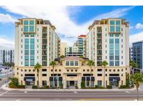 Upscale condo building exterior with attractive architecture, retail space, and manicured landscaping at 1227 E Madison St # 902, Tampa, FL 33602