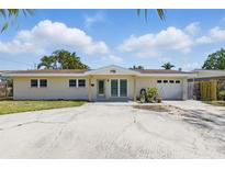 Charming single-story home with a spacious driveway and attached garage at 1524 Carson Ne Cir, St Petersburg, FL 33703