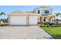 Charming home with a well-manicured lawn, a paved driveway, and a two-car garage at 2563 Ocean Breeze Ln, Clearwater, FL 33761