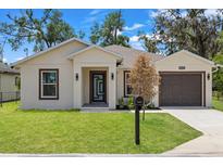 Charming single-story home with a well-manicured lawn and an attached one-car garage at 3803 E Curtis St, Tampa, FL 33610