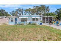 Charming single-story home with a well-maintained lawn, screened porch, and cheerful dolphin accents at 4707 Alma St, New Port Richey, FL 34652