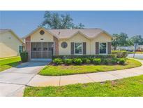 Charming single-story home with well-manicured lawn and mature landscaping in a quiet neighborhood at 4997 Bostonian Loop, New Port Richey, FL 34655