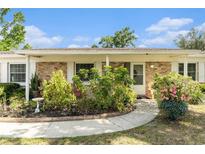 Charming home with a well-manicured front yard and colorful landscaping, enhancing curb appeal at 626 Marphil Loop, Brandon, FL 33511