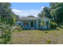 Charming single-story home with a welcoming front porch and well-manicured lawn at 6709 N 13Th St, Tampa, FL 33604