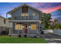 Charming two-story home with a front porch and second story balcony, plus a red front door at 757 32Nd N Ave, St Petersburg, FL 33704