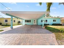 Charming home featuring a spacious carport and a brick driveway at 1025 Boca Ciega Isle Dr, St Pete Beach, FL 33706