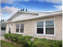 Charming single-story home featuring a stone facade, well-maintained landscaping, and bright, modern windows at 12400 Park Blvd # 522, Seminole, FL 33772