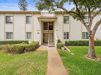 Inviting condo featuring a well-manicured lawn and sidewalk leading to the front entry at 129 Cypress Ct, Oldsmar, FL 34677