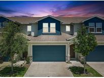 Beautiful townhome with a two-car garage and manicured landscaping, creating curb appeal at 1510 Blue Sea St, Clearwater, FL 33756