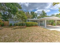 Charming single-story home with a covered carport and mature landscaping creating curb appeal at 1511 Meridel Ave, Tampa, FL 33612