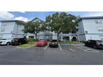 Inviting condo exterior featuring well-maintained landscaping and accessible parking at 1530 Villa Capri Cir # 302, Odessa, FL 33556