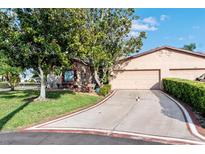 Charming single-story home with mature trees, a driveway and a two-car garage at 1823 Atrium Dr, Sun City Center, FL 33573