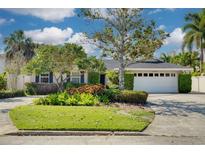 Charming single-Gathering home with mature landscaping, a well-manicured lawn, and a two-car garage at 219 Miramar Ne Blvd, St Petersburg, FL 33704