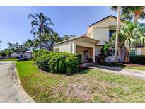 Charming home with lush landscaping, mature trees, and a welcoming entrance at 2600 Forest Run Ct, Clearwater, FL 33761