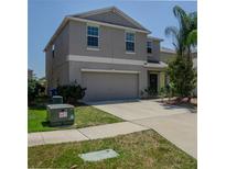 Two-story home with an attached two-car garage, concrete driveway and low-maintenance landscaping at 6707 Blue Moon Way, Sun City Center, FL 33573