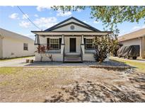 Charming single-story home with a covered front porch and a well-manicured yard at 7509 S West Shore Blvd, Tampa, FL 33616