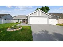 Charming single-story home featuring a well-maintained lawn and a two-car garage at 8728 Mcadam Pl, Tampa, FL 33634