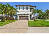 Stunning two-story home with a paver driveway, tropical landscaping, and a two-car garage at 101 Biscayne Ave, Tampa, FL 33606