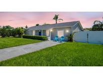 Charming single-story home with a well-manicured lawn and inviting curb appeal at 1011 Coldstream Ct, Tarpon Springs, FL 34689