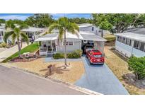 Charming single Gathering home with a well-manicured lawn and a two car covered parking spot at 123 Saint Kitts Way, Apollo Beach, FL 33572
