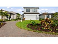 Charming two-story home with lush landscaping and a paved driveway at 16415 Sapphire Point Dr, Lakewood Ranch, FL 34211