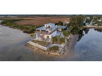 Stunning waterfront home with a private deck, spiral staircase, and lush landscaping at 2417 Sunset Vista Dr, Spring Hill, FL 34607