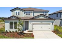 Charming two-story home featuring a two-car garage, manicured lawn, and fresh landscaping at 37202 Clinch Cir, Zephyrhills, FL 33540