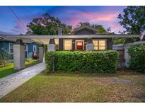 Charming bungalow featuring a cozy front porch, brick pillars and lush green hedge at 4803 Highland, Tampa, FL 33603