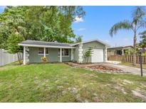 Charming home featuring a lush lawn, mature trees, and a one-car garage at 5245 3Rd N Ave, St Petersburg, FL 33710