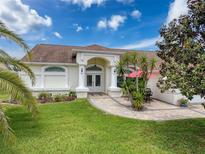 Charming single-story home with a well-manicured lawn and beautiful landscaping at 9253 Water Hazard Dr, Hudson, FL 34667
