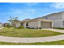 Charming single-story home with a well-manicured lawn and two-car garage in a Gathering-friendly neighborhood at 10360 Honeysuckle Vine Cir, Riverview, FL 33578