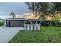 Charming single-story home with a well-manicured lawn and a two-car garage in a quiet neighborhood at 1211 64Th Nw St, Bradenton, FL 34209
