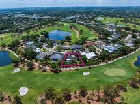 Stunning aerial view of home on golf course with lush landscaping and water features at 16 Hibiscus Rd, Belleair, FL 33756